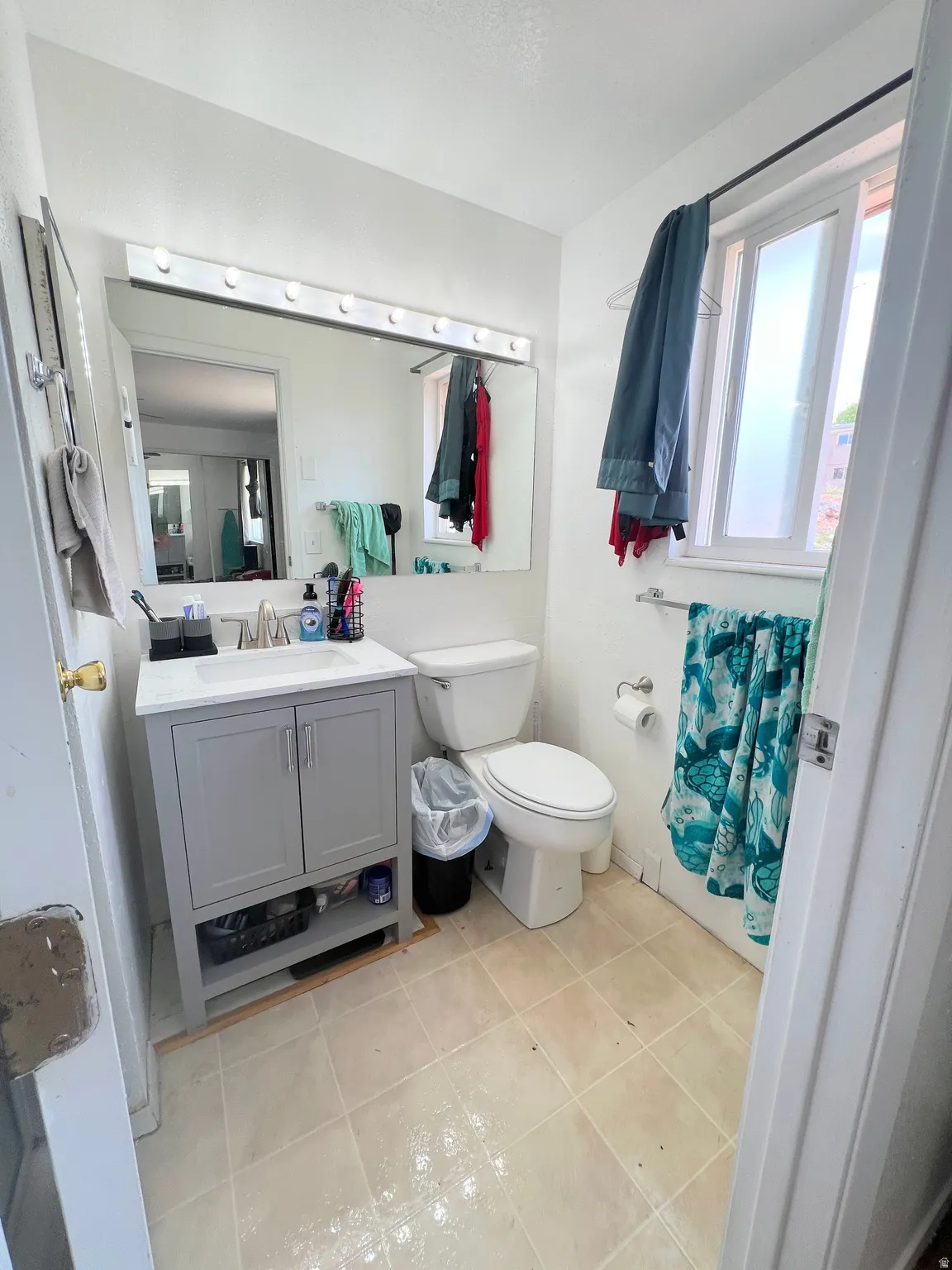 3/4 bath with vanity and light tile patterned flooring