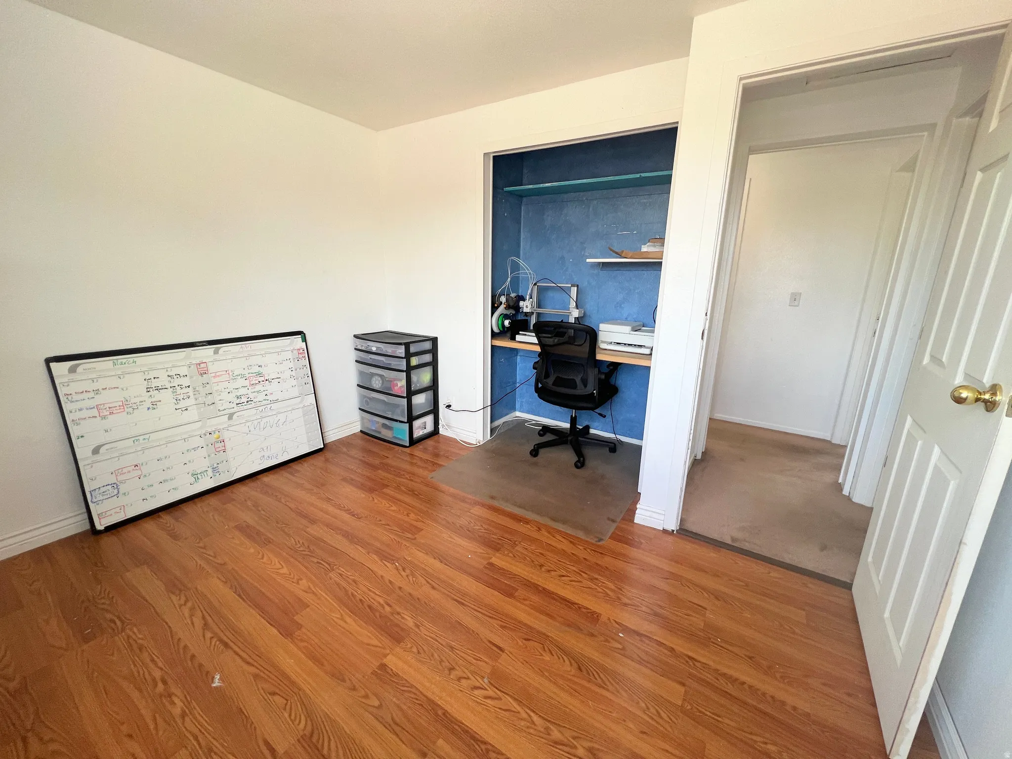 Home office with wood finished floors and baseboards