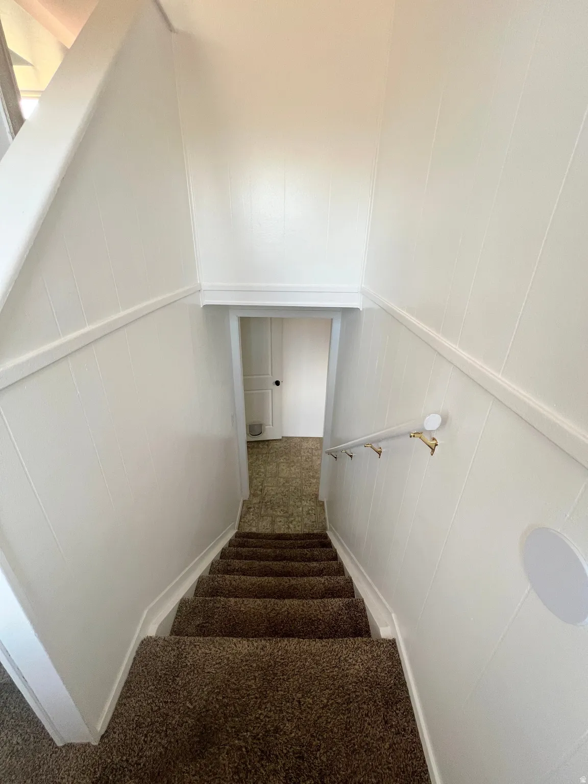 Staircase featuring carpet
