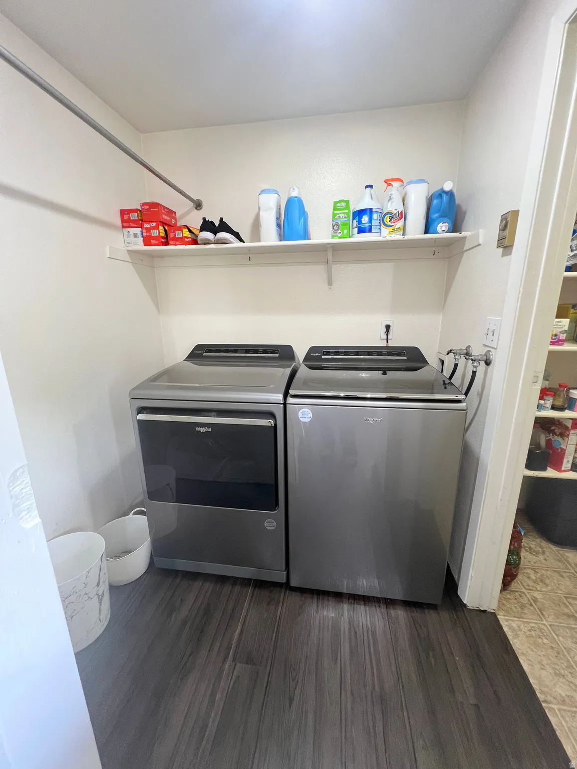 Laundry area featuring dark wood-style flooring and separate washer and dryer