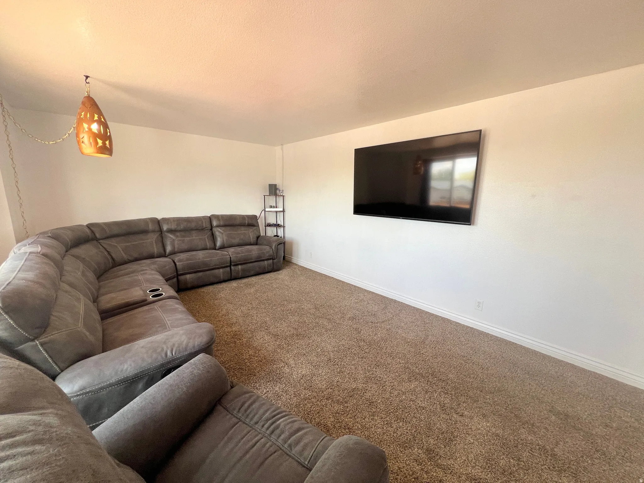 Carpeted living room with baseboards