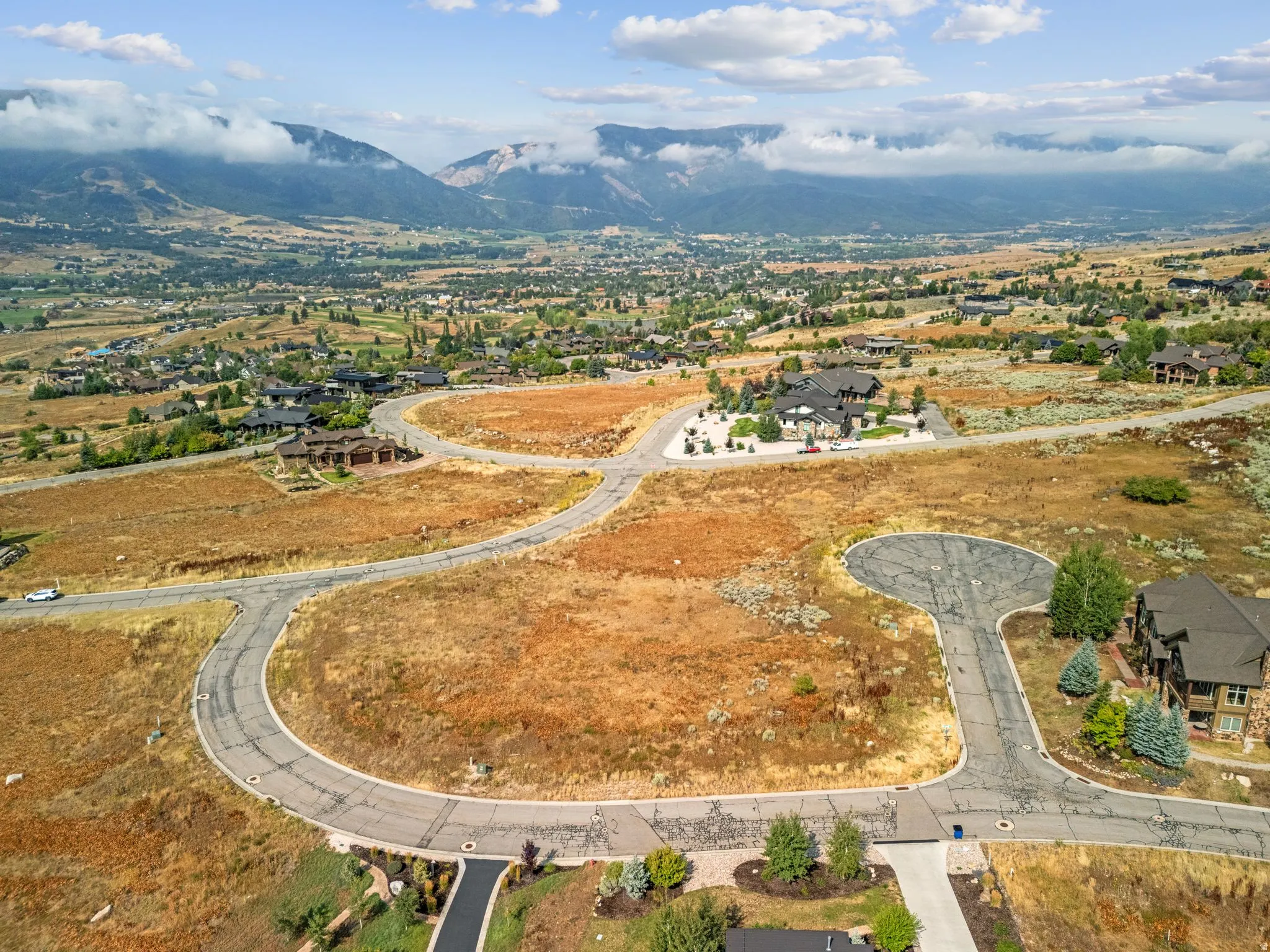 View of property location with a mountain backdrop and nearby suburban area