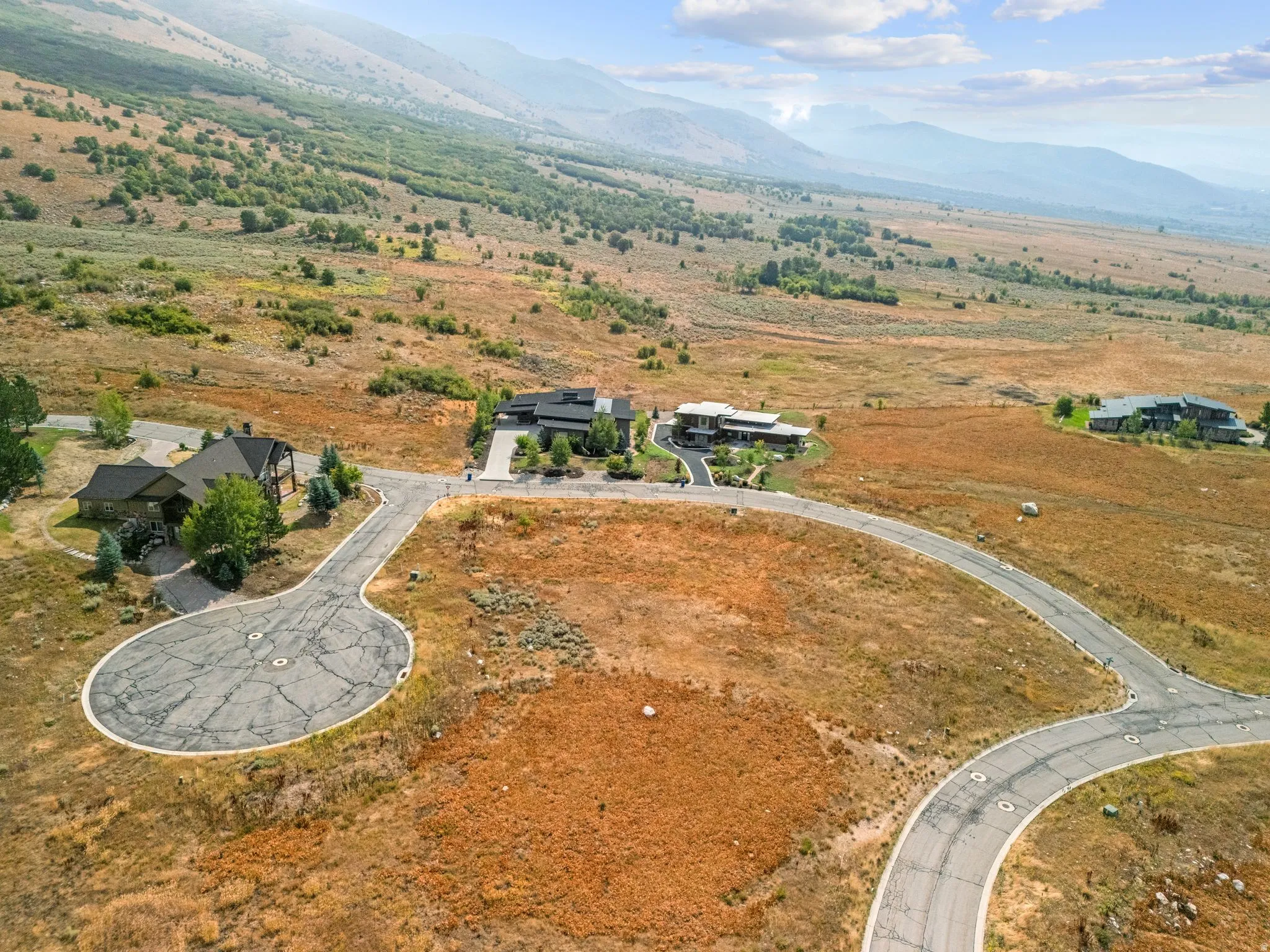 Aerial view of property's location featuring a mountain backdrop and rural landscape