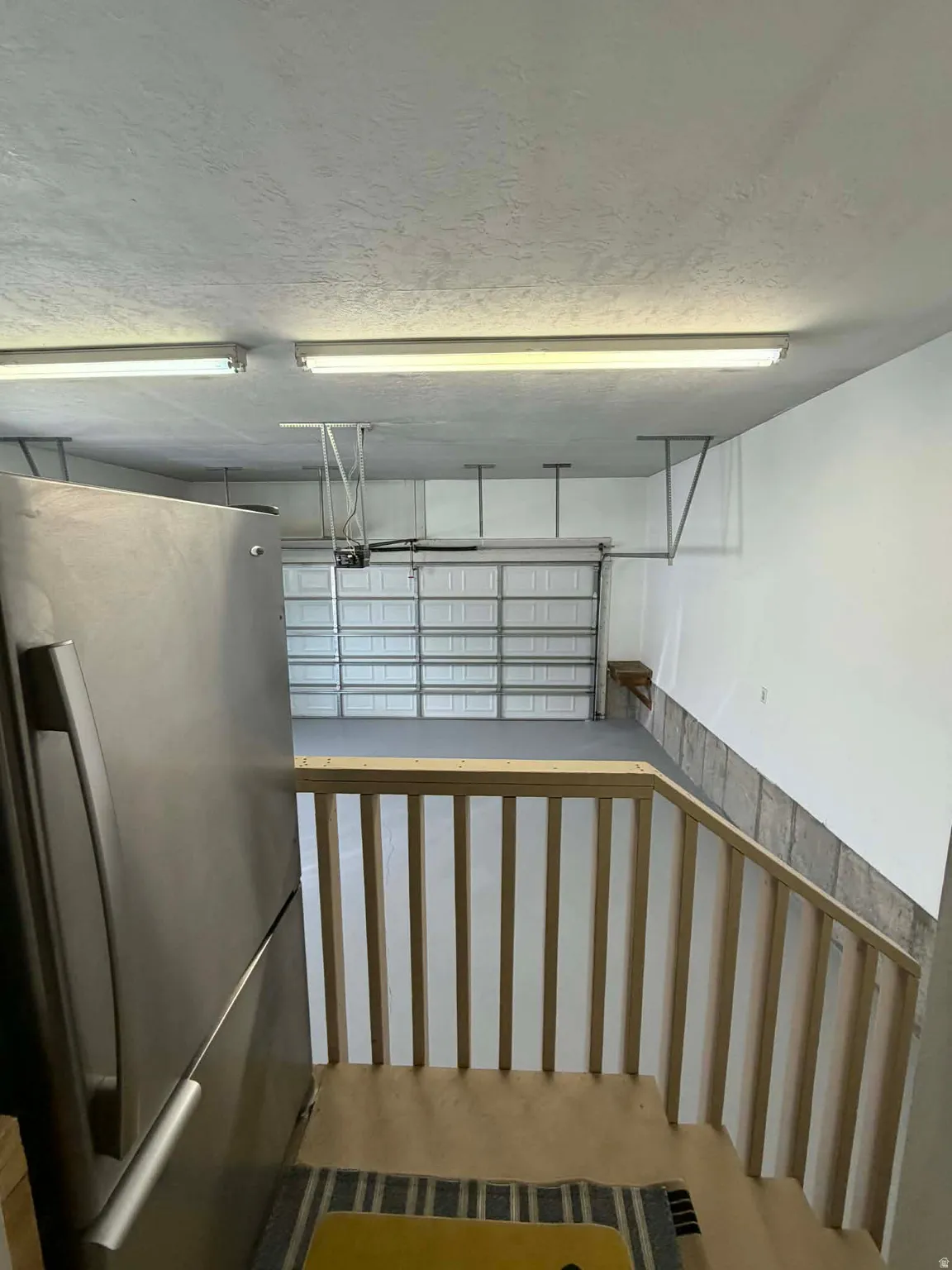 Garage featuring freestanding refrigerator