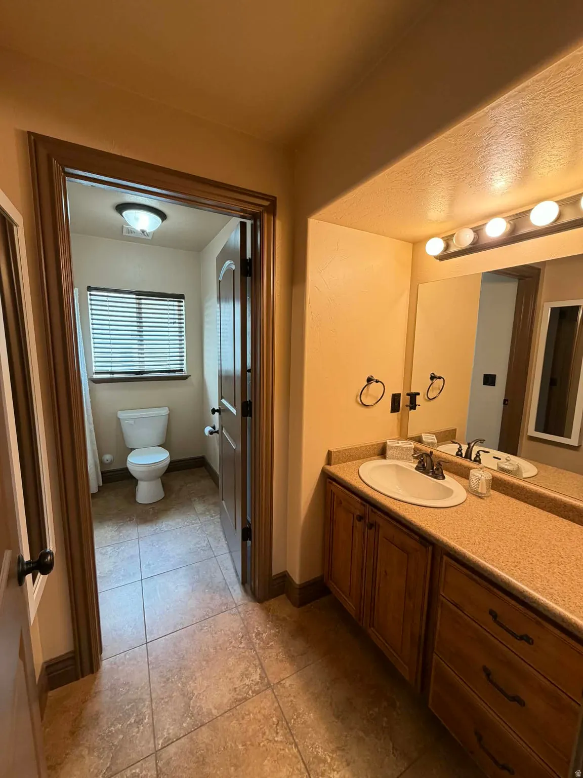 Bathroom featuring vanity and light tile patterned flooring