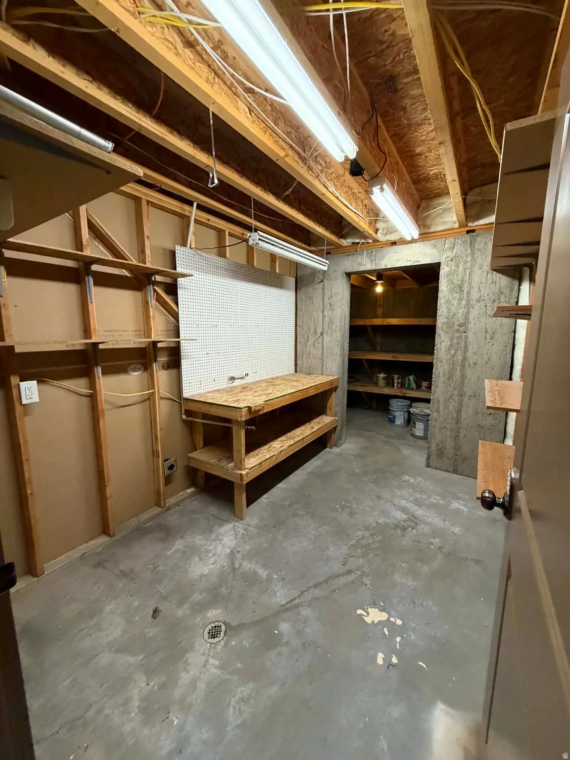 Unfinished below grade area featuring a workshop area