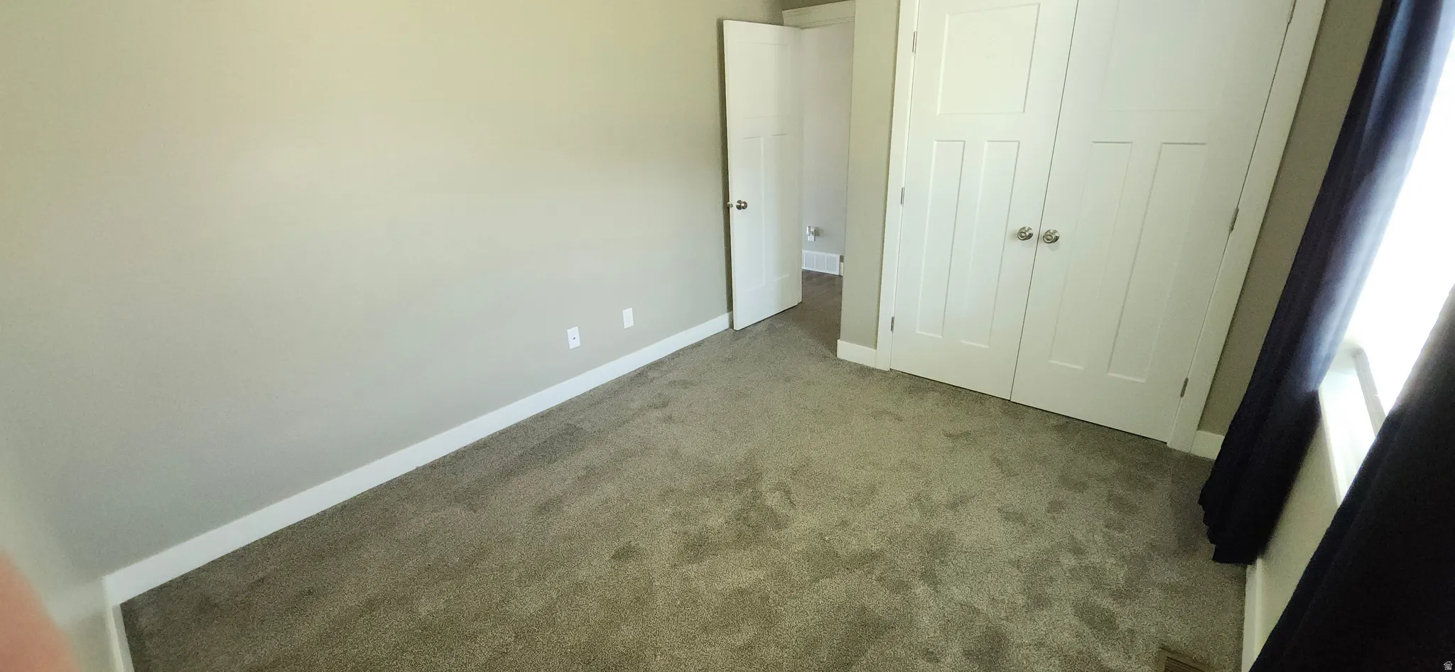 Unfurnished bedroom featuring carpet floors and a closet