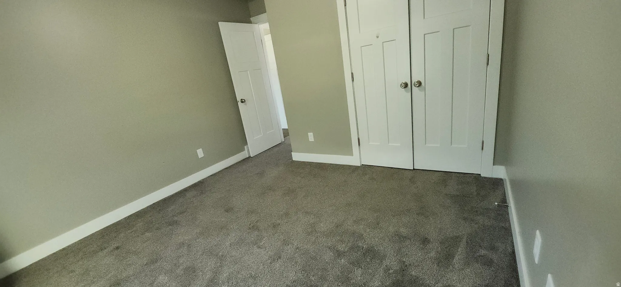Unfurnished bedroom featuring carpet and a closet