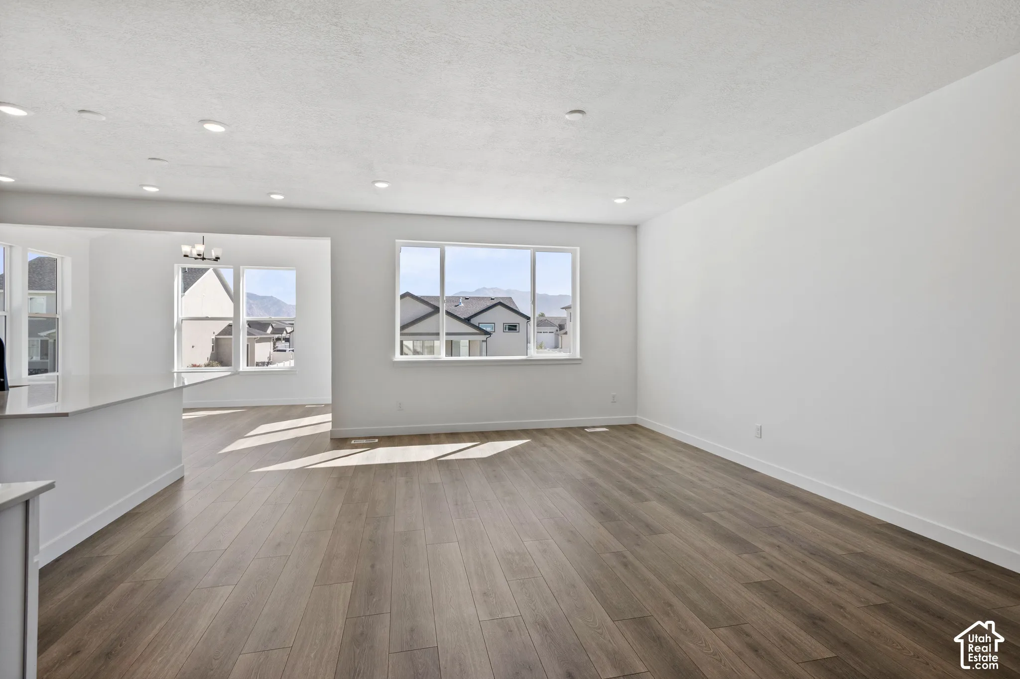Wood-finish flooring, recessed lighting, and expansive windows