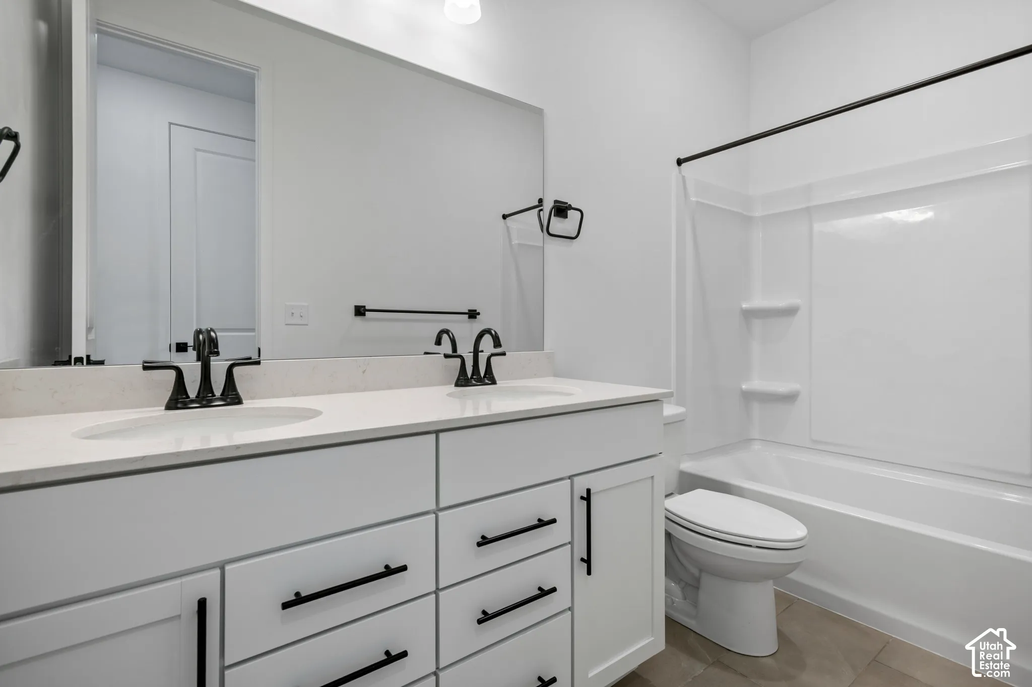 Dual vanity with white cabinetry and matte black hardware