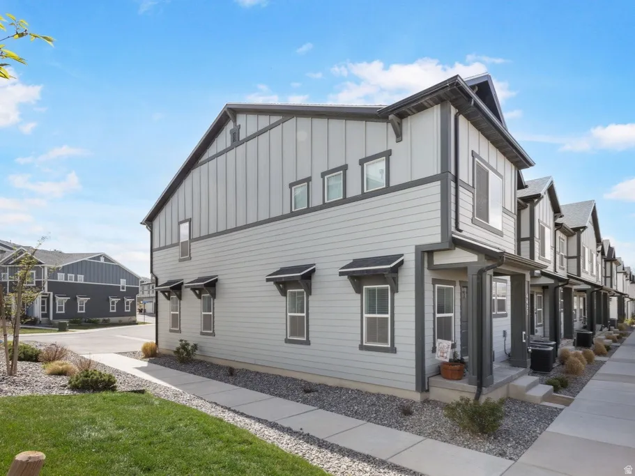 View of property exterior with board and batten siding and a residential view