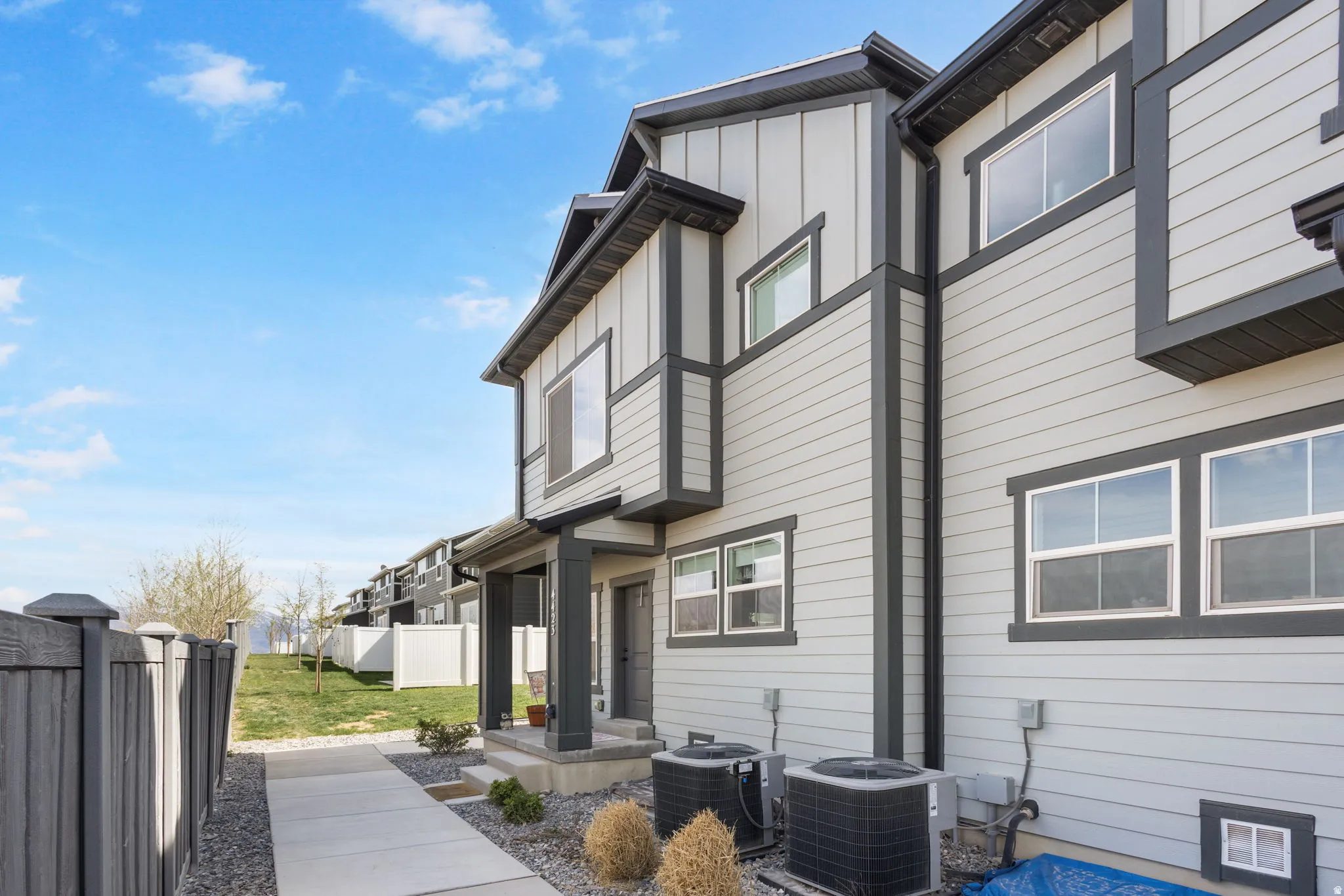 View of home's exterior with a central air condition unit and board and batten siding