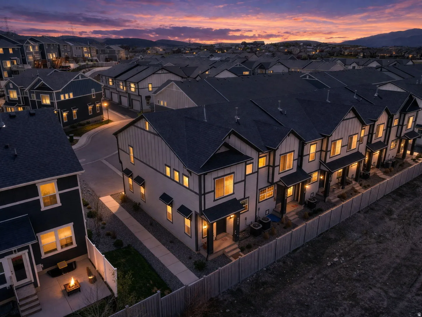 Modern townhome row featuring vertical siding and dark trim accents