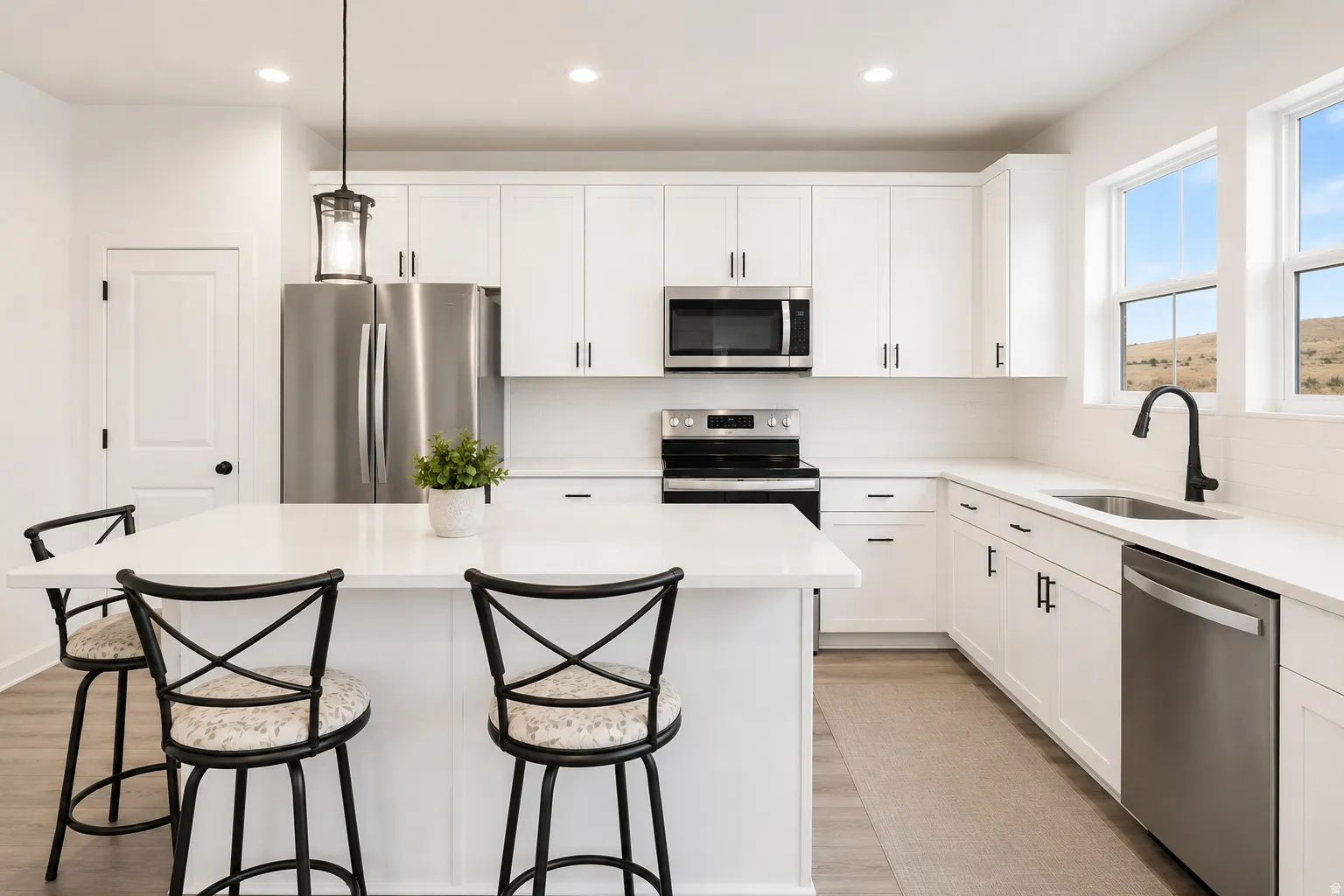 Contemporary kitchen featuring white cabinetry and stainless steel appliances