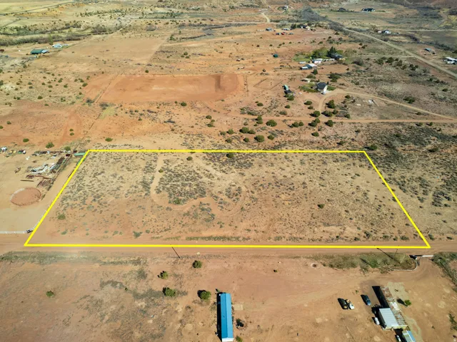 Aerial view of sparsely populated area featuring property boundaries highlighted and a desert landscape