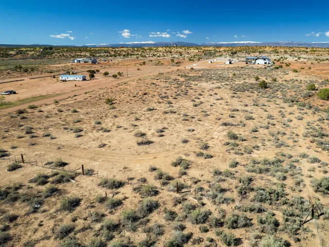 Aerial view of sparsely populated area featuring a desert landscape and a mountainous background