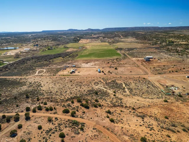 Aerial view of property and surrounding area featuring rural landscape and mountains