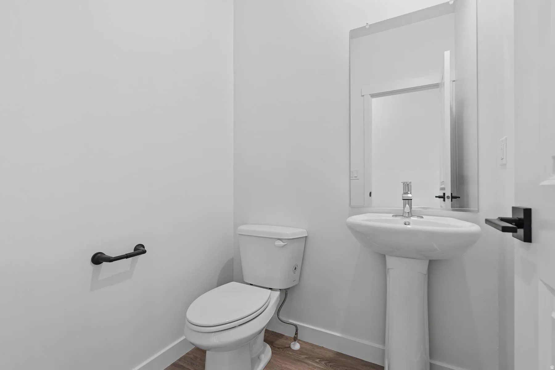 Bathroom featuring toilet and wood finished floors