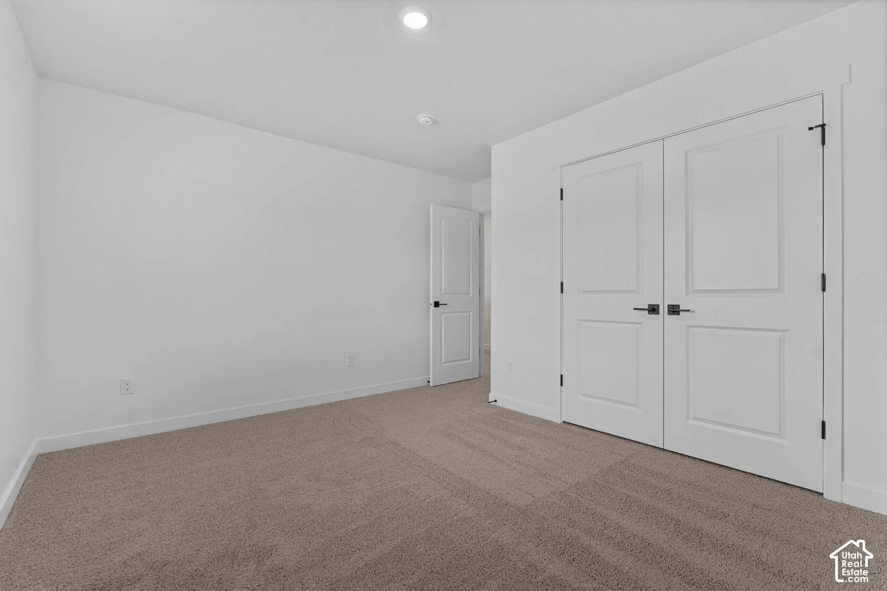 Unfurnished bedroom featuring carpet, a closet, and recessed lighting