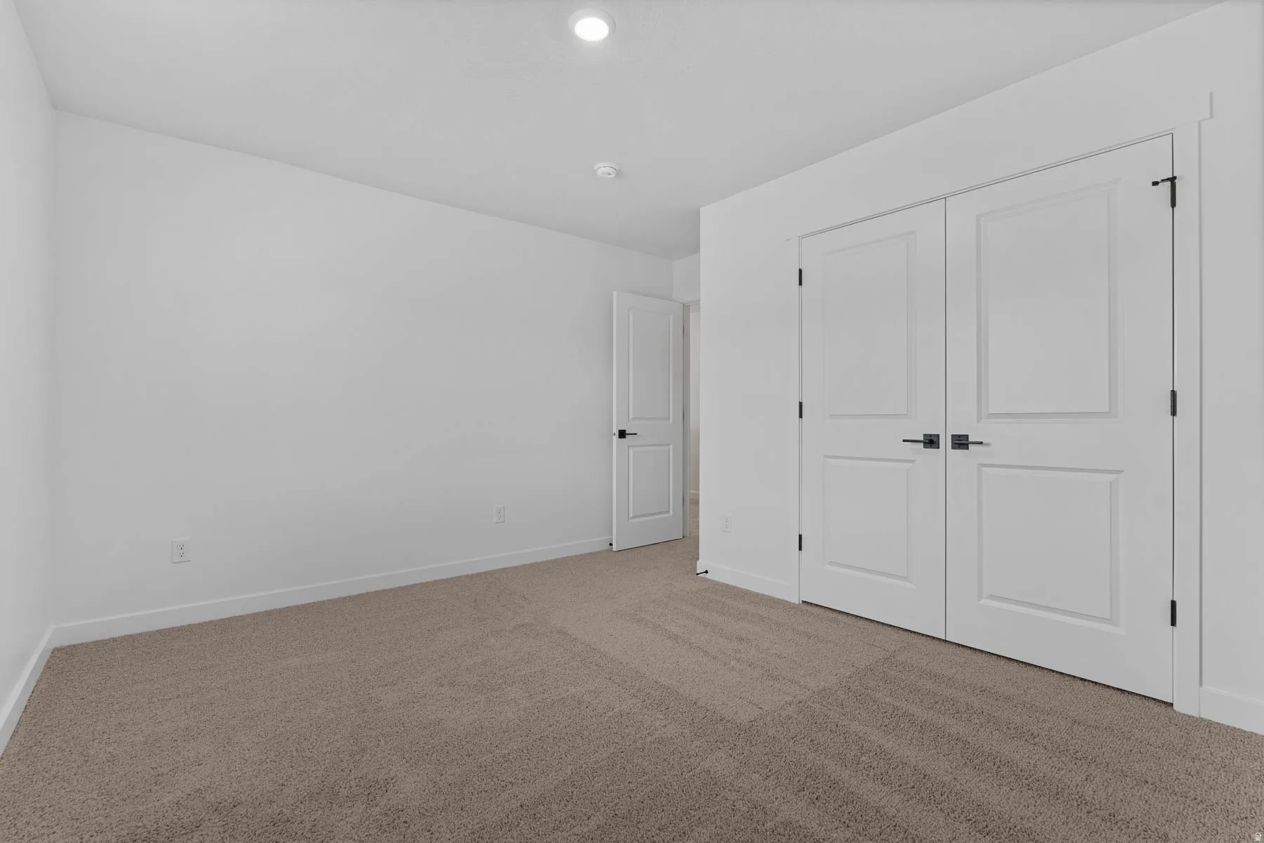 Unfurnished bedroom featuring carpet, a closet, and recessed lighting