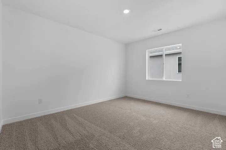 Unfurnished room with carpet flooring and baseboards