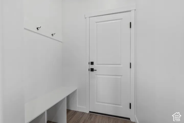 Mudroom featuring dark wood-style flooring