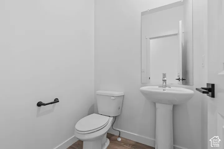Bathroom featuring toilet and wood finished floors