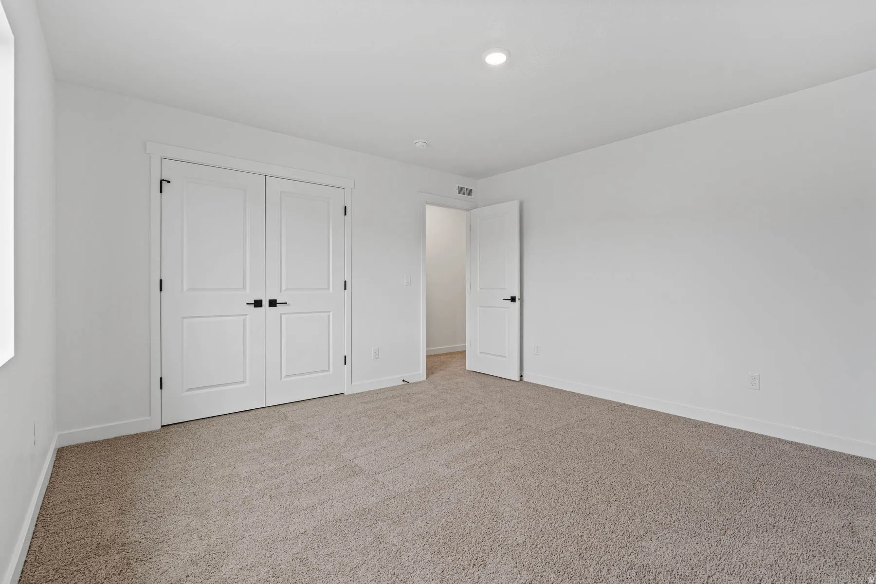 Unfurnished bedroom featuring carpet floors and a closet