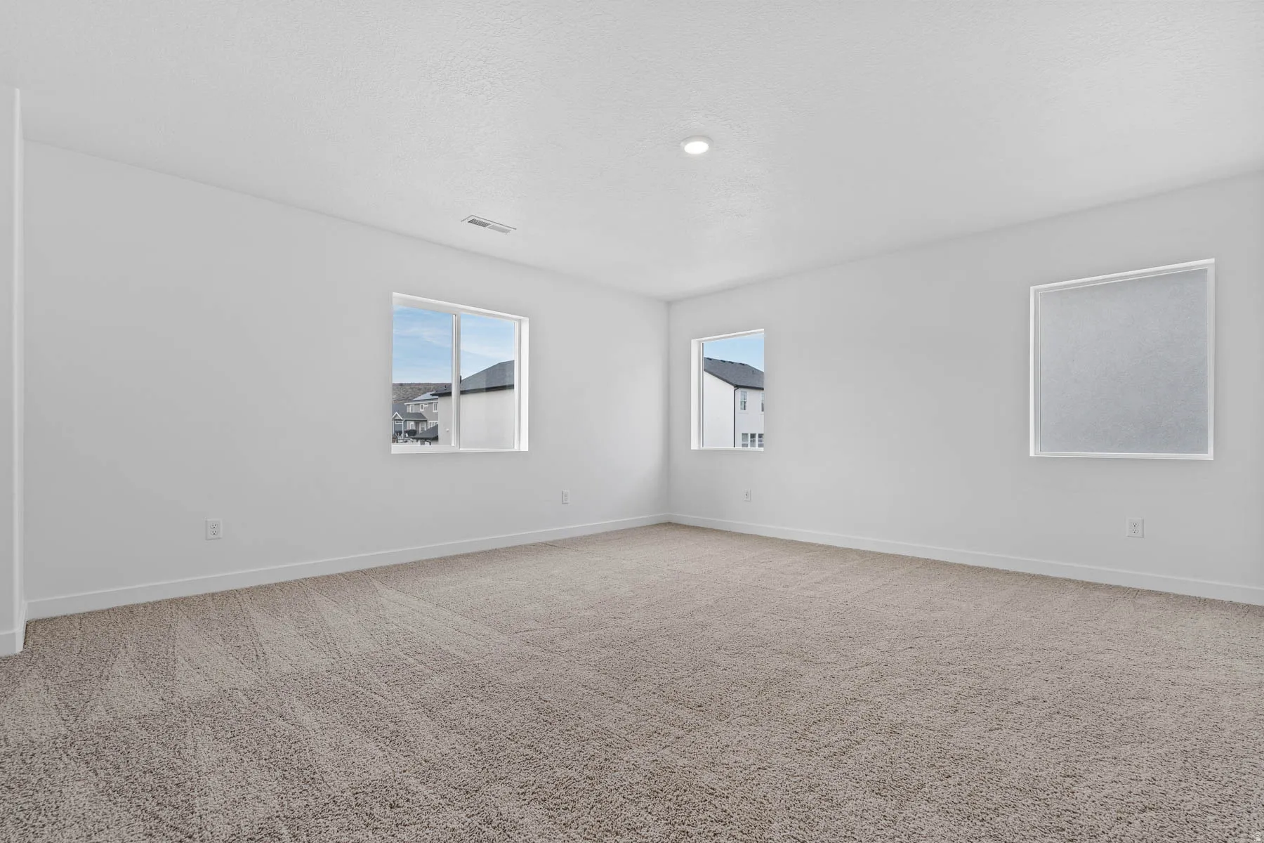 Unfurnished room with light colored carpet and baseboards