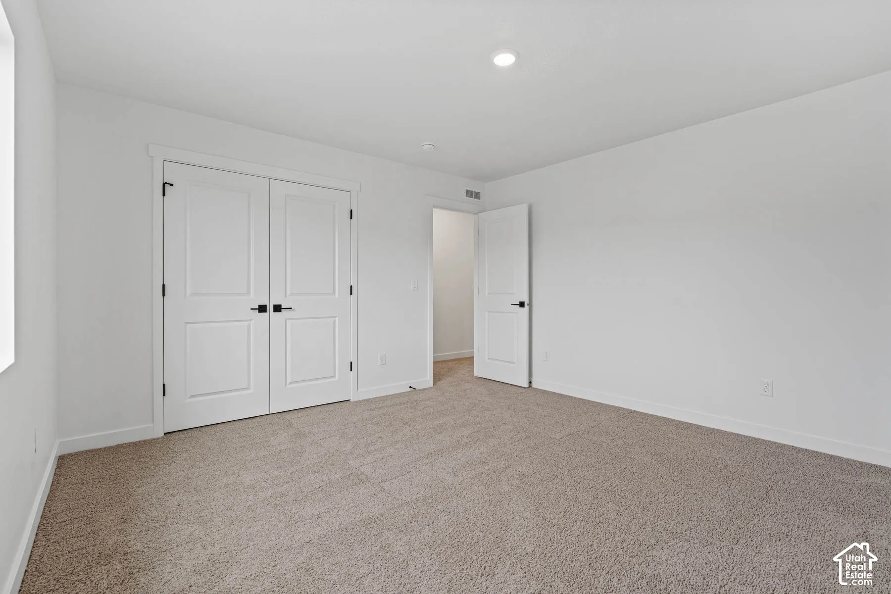 Unfurnished bedroom featuring carpet floors and a closet