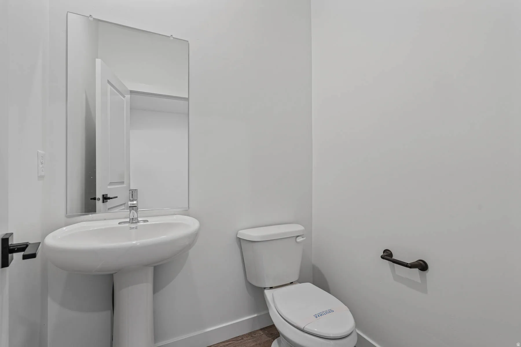 Bathroom featuring toilet and baseboards