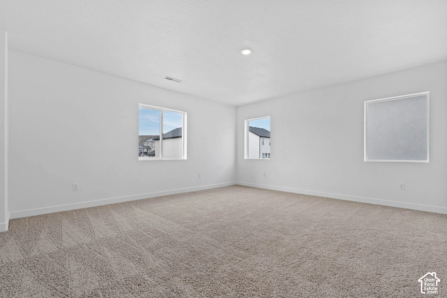 Unfurnished room with light colored carpet and baseboards