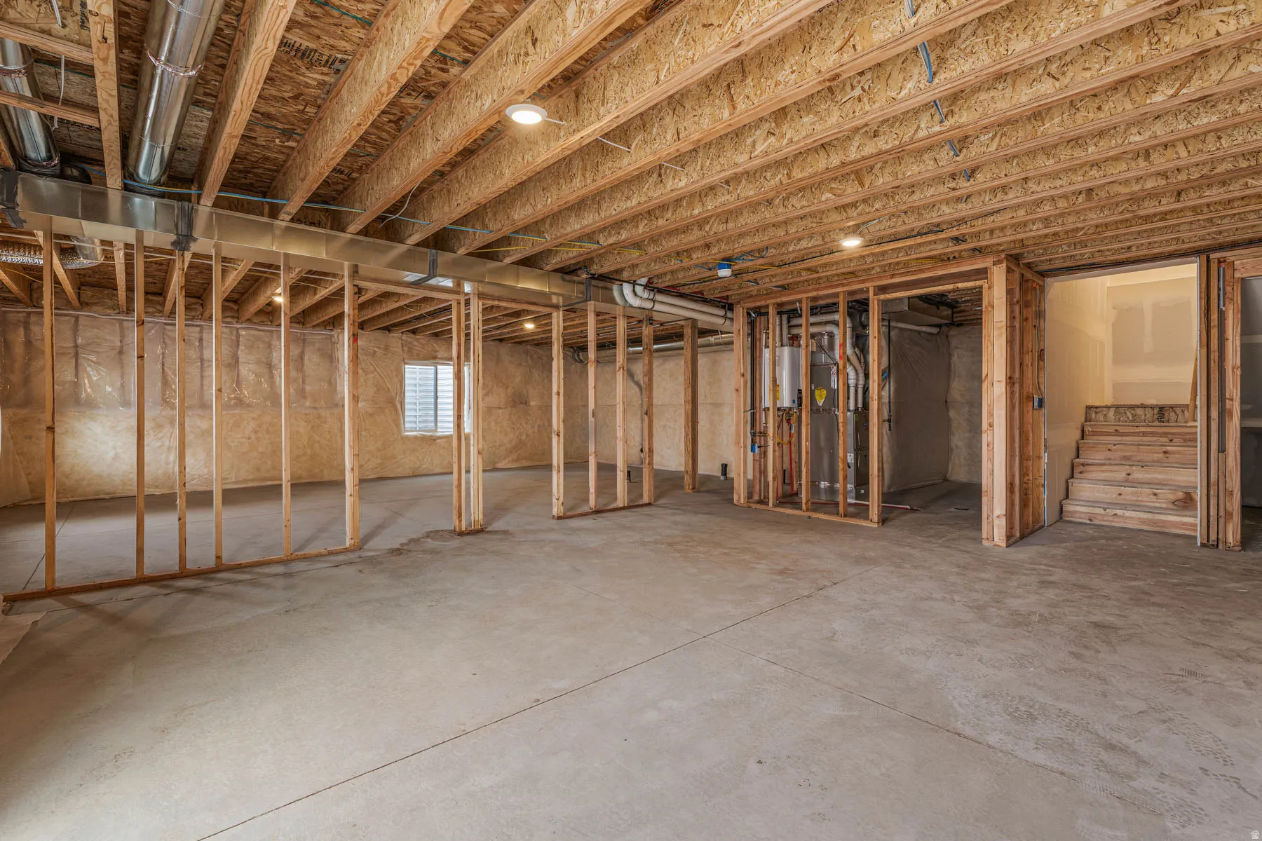Basement with stairs and heating unit