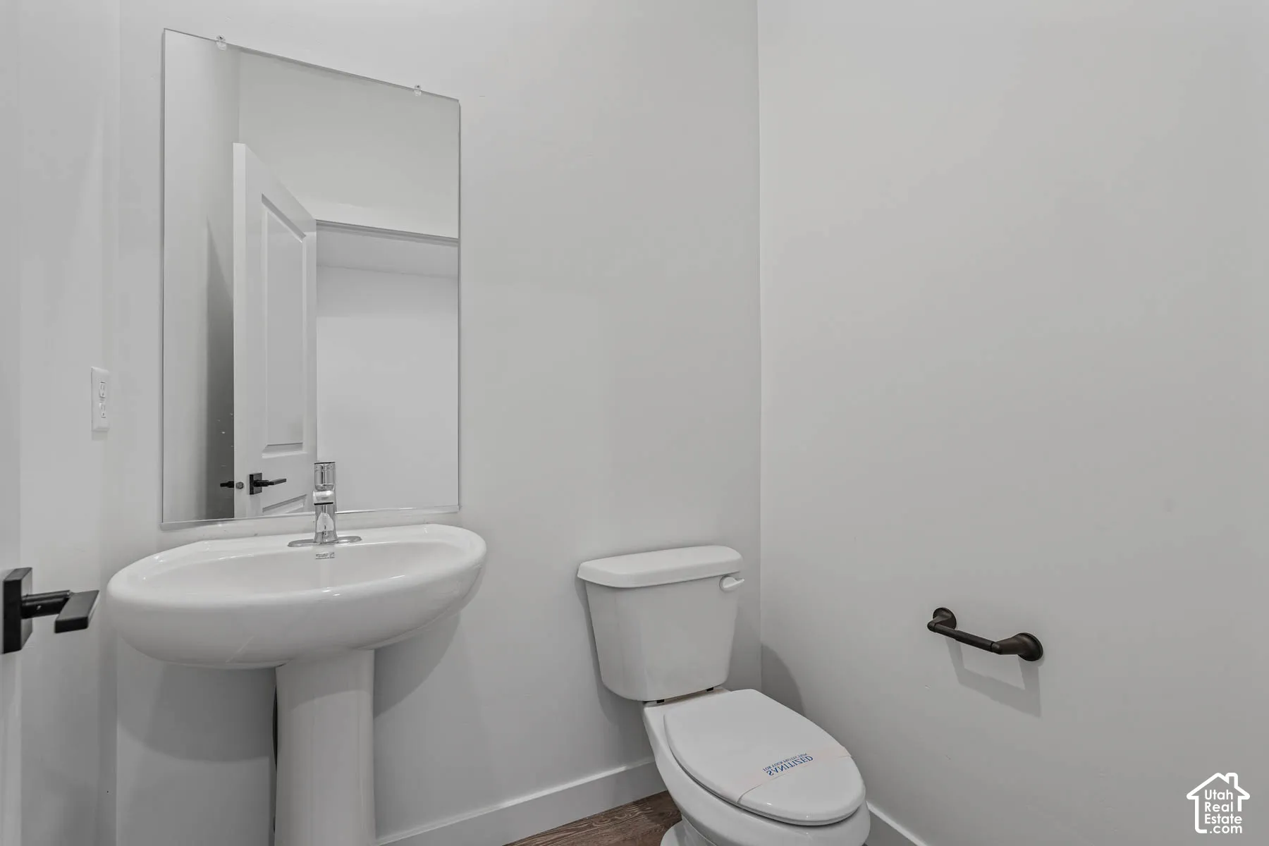 Bathroom featuring toilet and baseboards