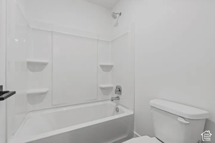 Bathroom featuring toilet and  shower combination
