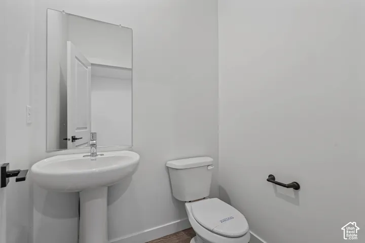 Bathroom featuring toilet and baseboards