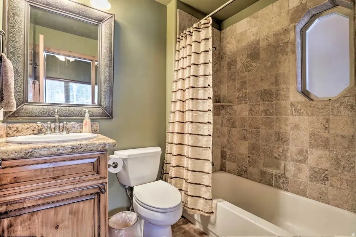 Full bathroom with vanity and shower / tub combo