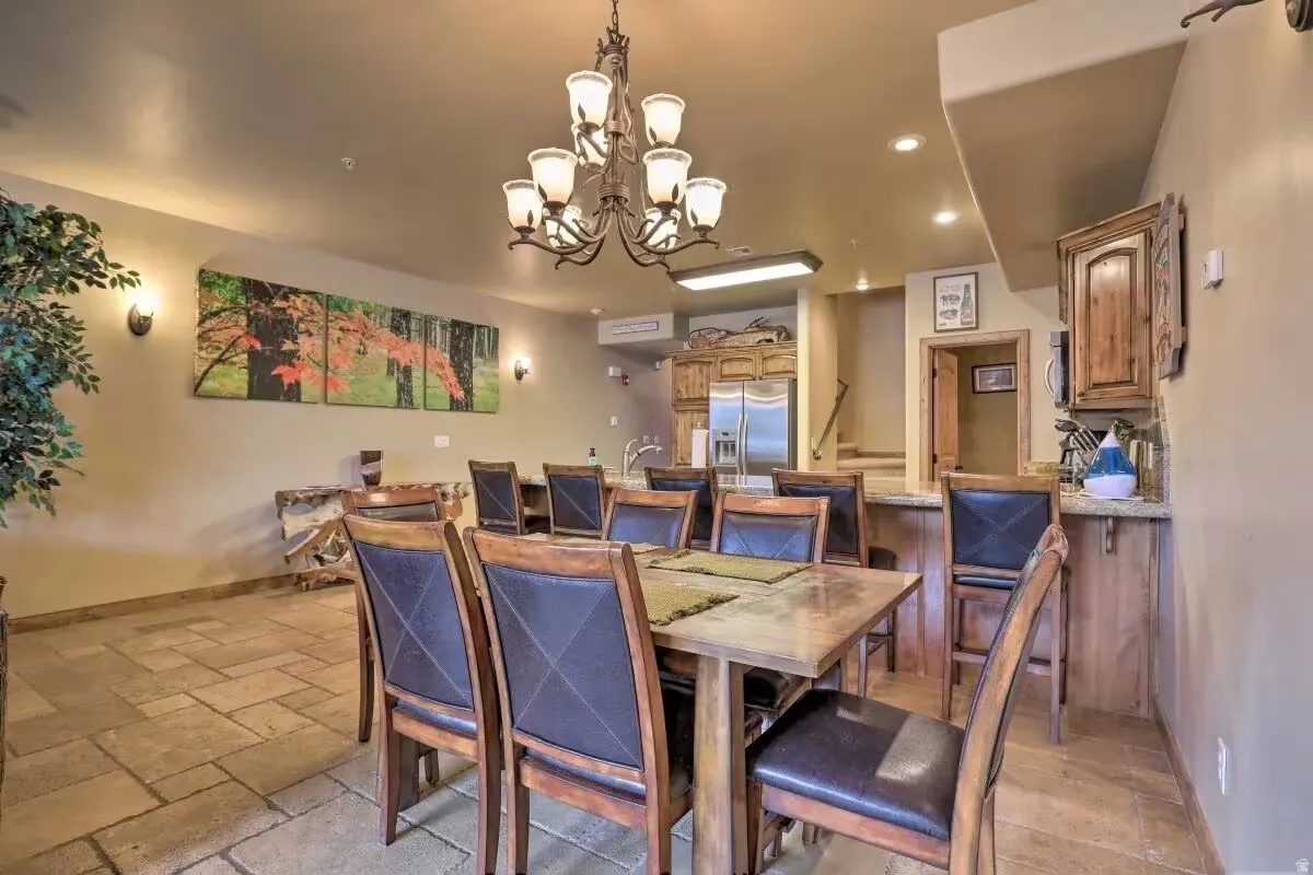 Dining room featuring a chandelier and stone tile flooring