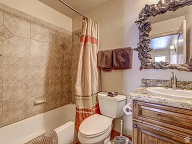 Bathroom featuring vanity and shower / bath combo