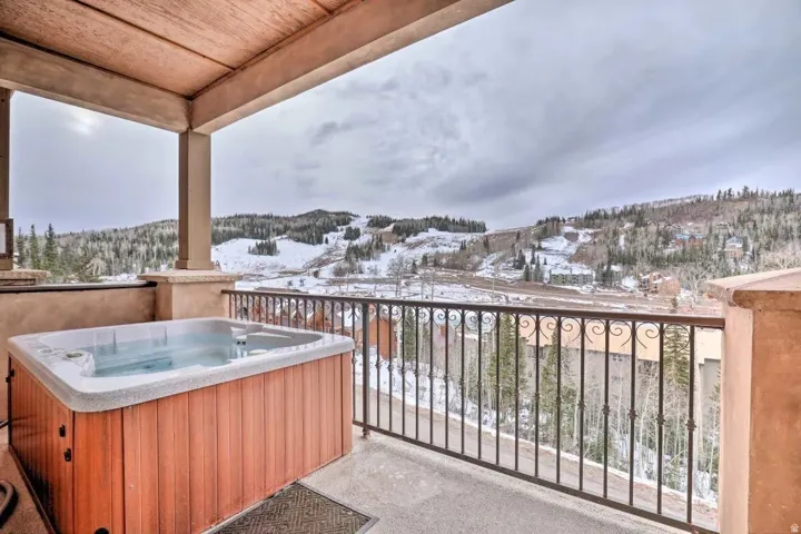 Main deck with hot tub overlooking valley