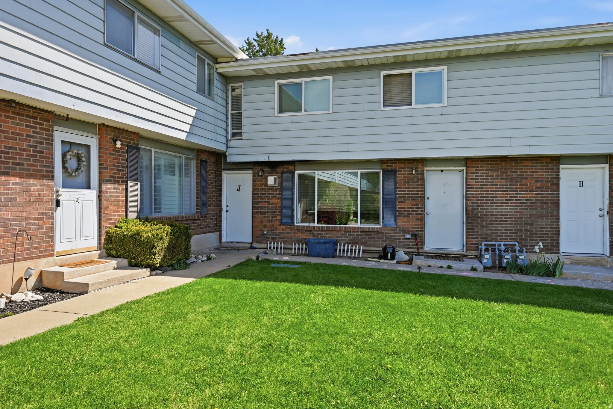 View of front of home featuring entry steps and brick siding