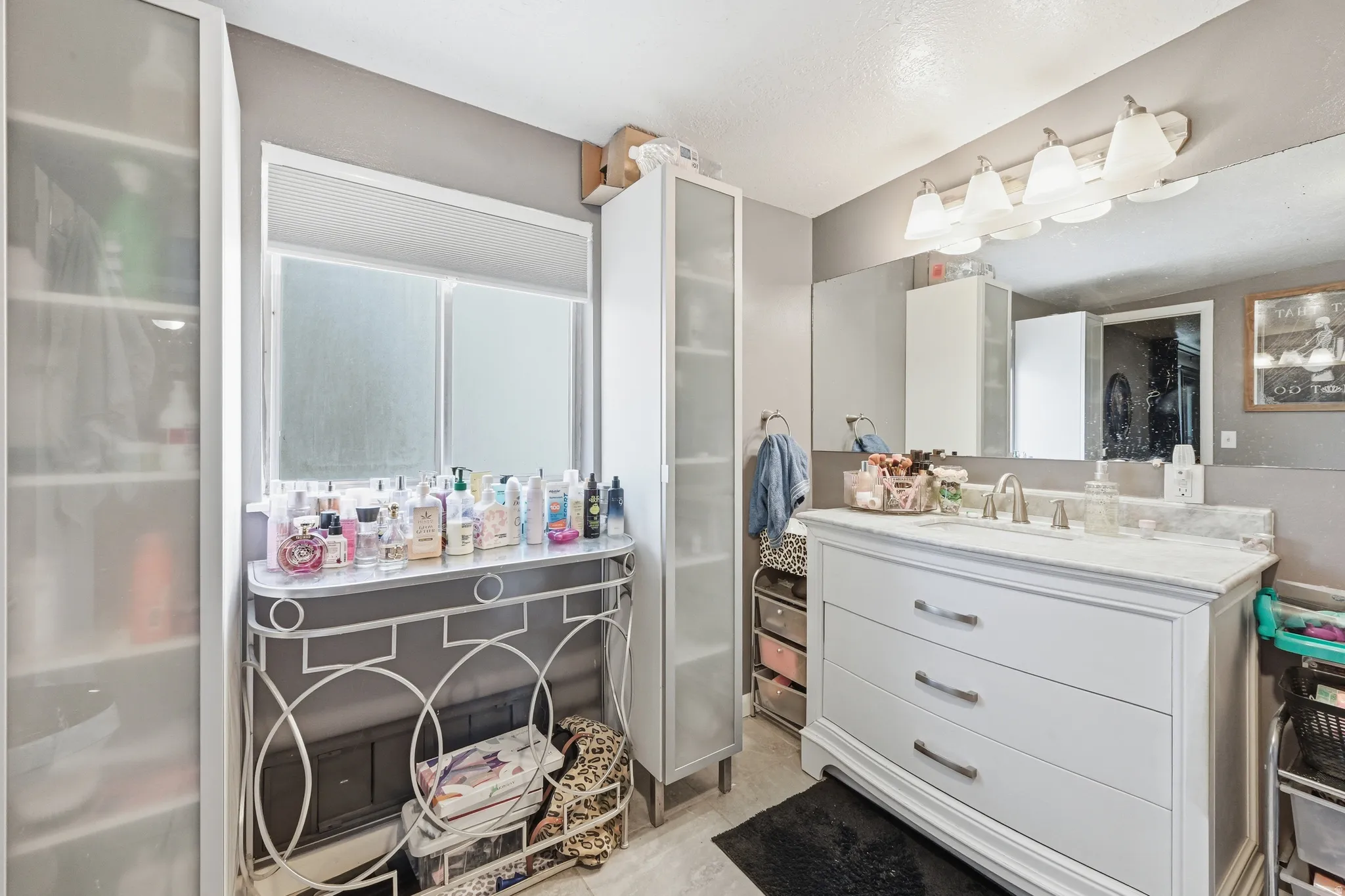 Full bath with vanity and light tile patterned floors