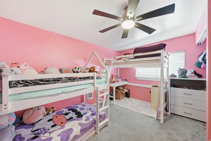 Bedroom #2 - featuring light colored carpet and ceiling fan