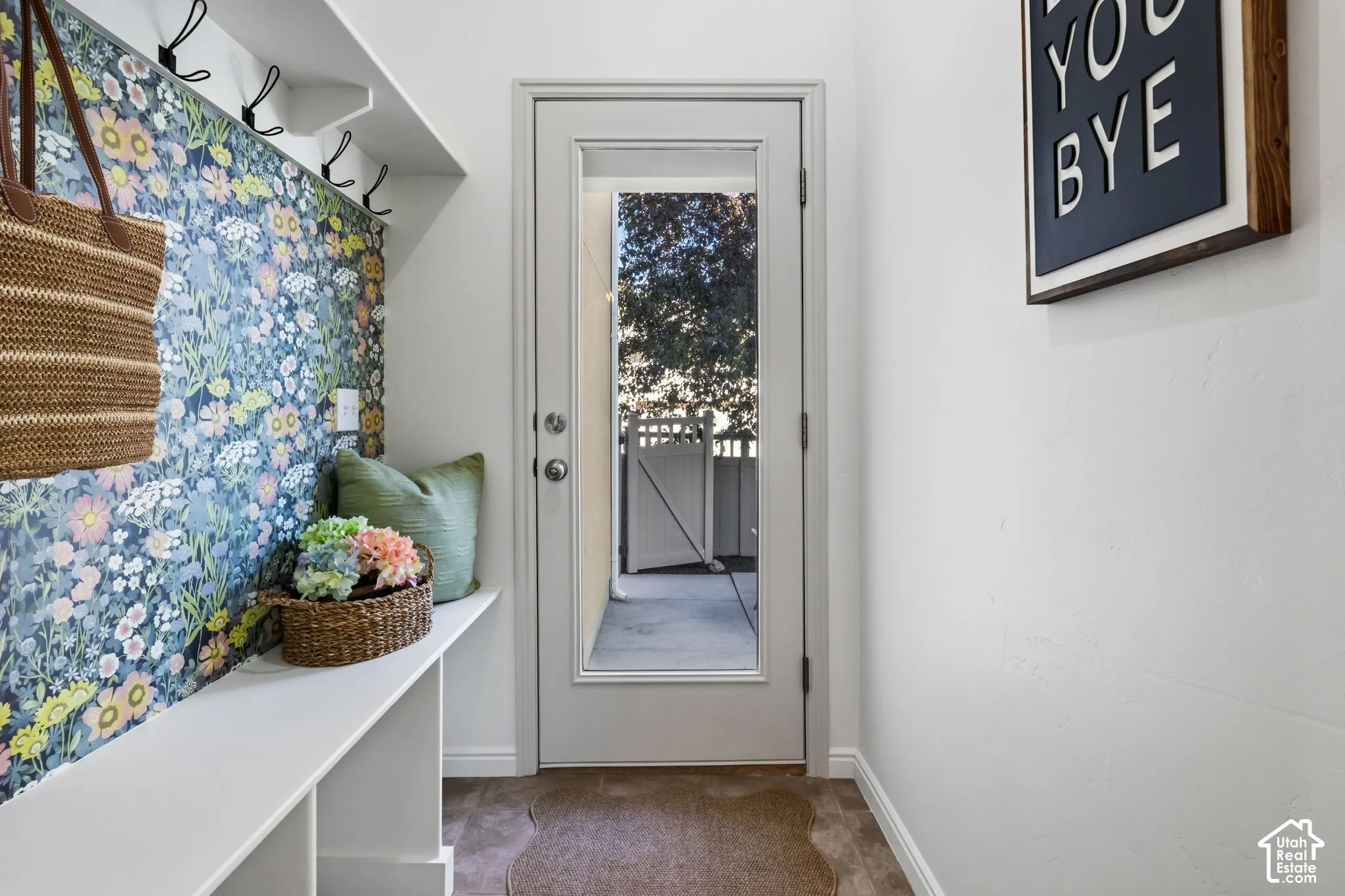 Entryway featuring a built-in bench, coat hooks, and a glass-paneled door