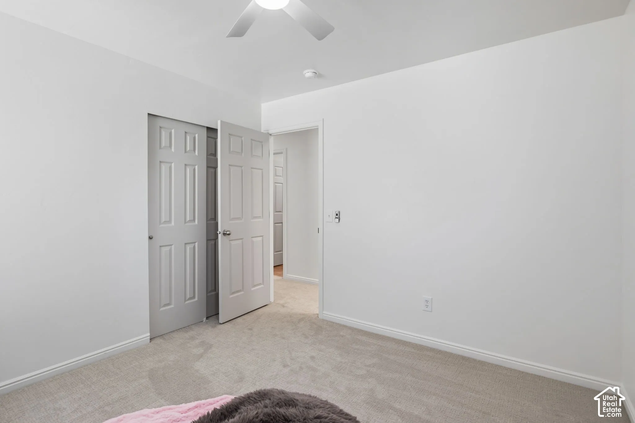 Light gray carpeting with white baseboards
