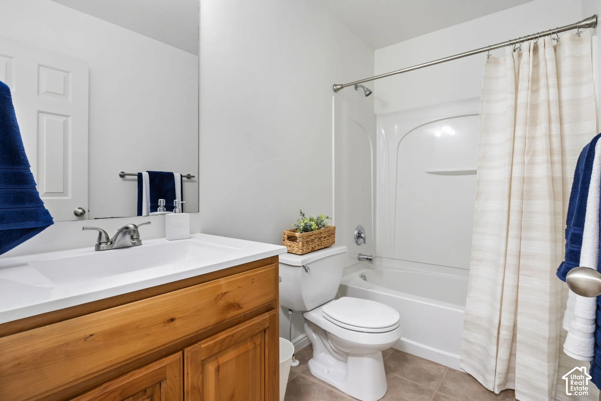 White single-piece vanity countertop with an integrated sink and brushed nickel faucet