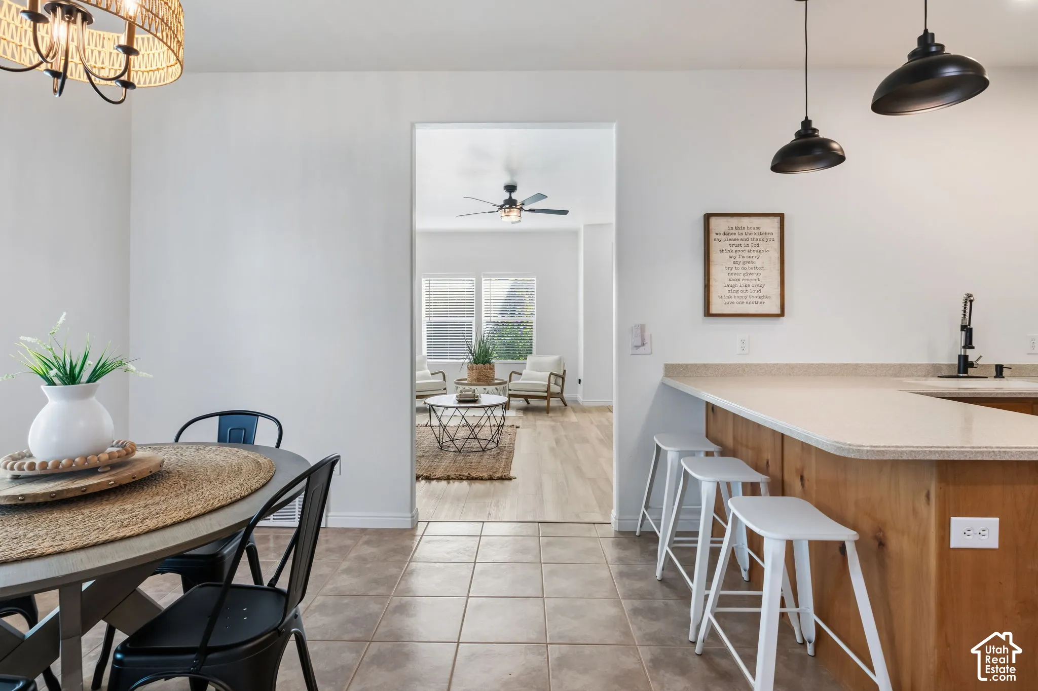 Open-concept layout with tile flooring, wood-finish kitchen island, light-colored countertops, and recessed lighting
