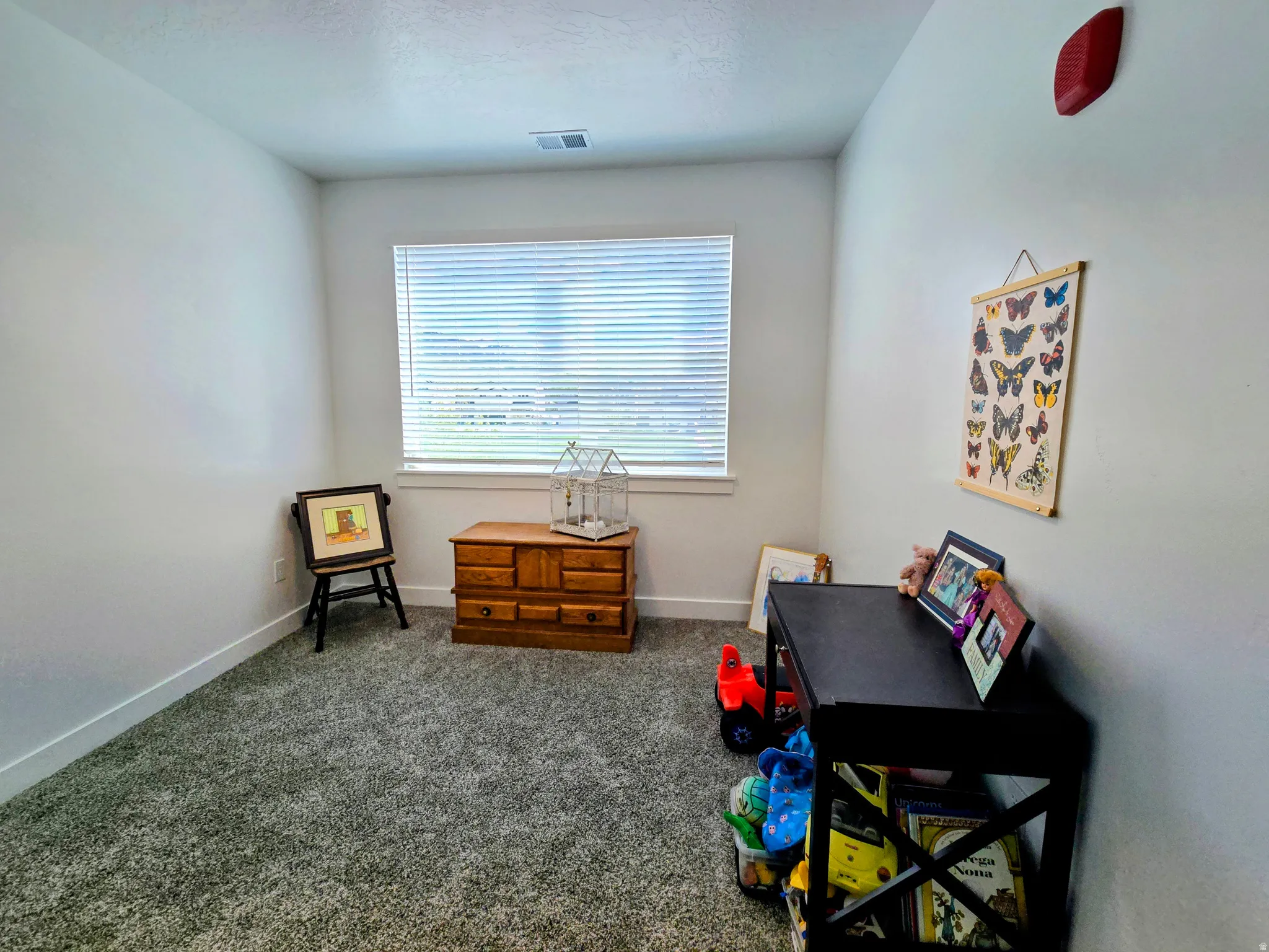 Recreation room with dark carpet and baseboards
