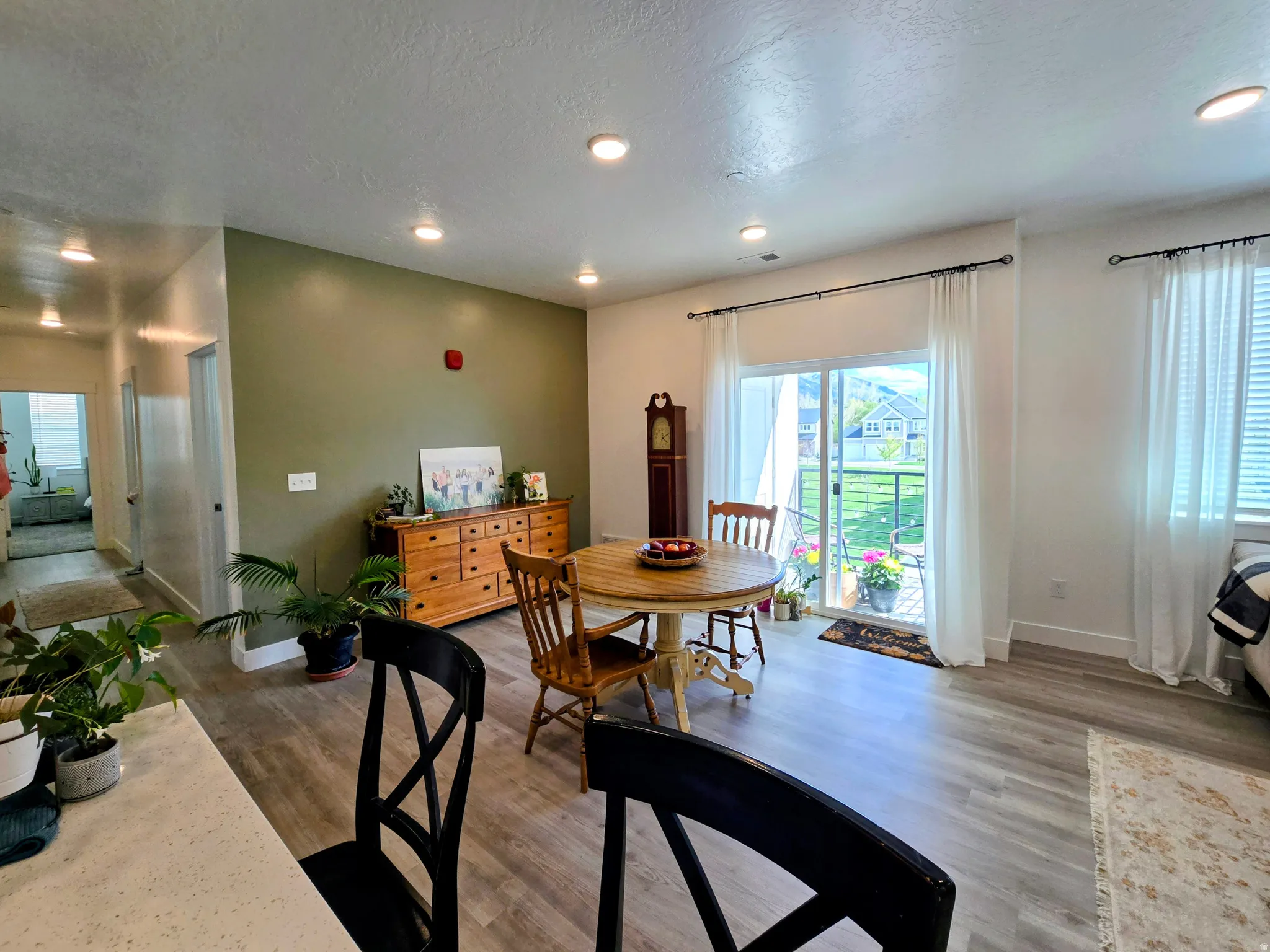 Dining space featuring recessed lighting, dark wood-style floors, plenty of natural light, and a textured ceiling