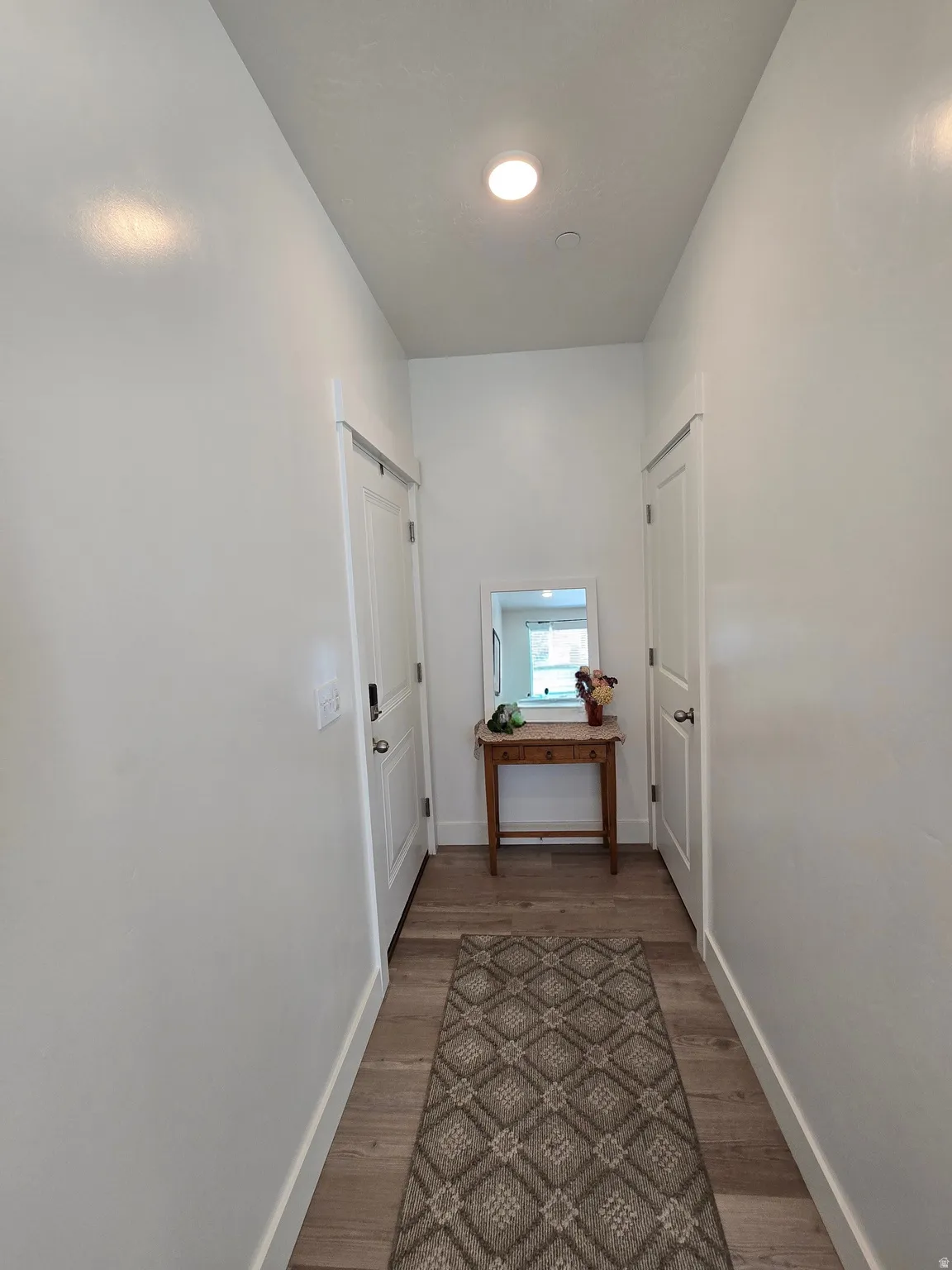 Hallway featuring baseboards and light wood-style floors